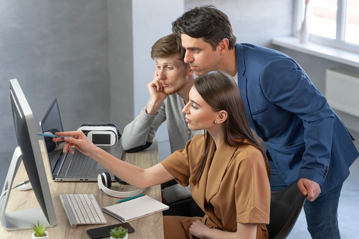 side view team professionals working with new technology 23 2148901148